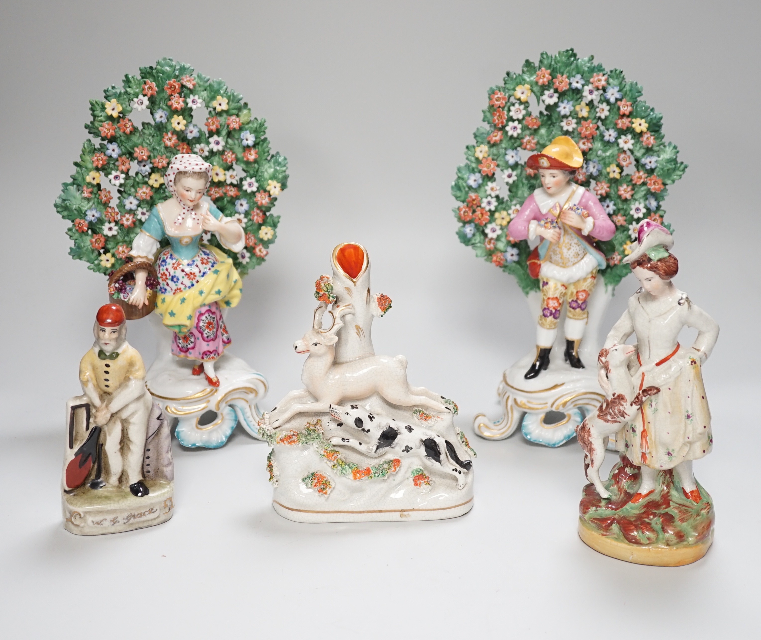 A pair of Derby style bocage figures and three other figures, tallest 26cms high